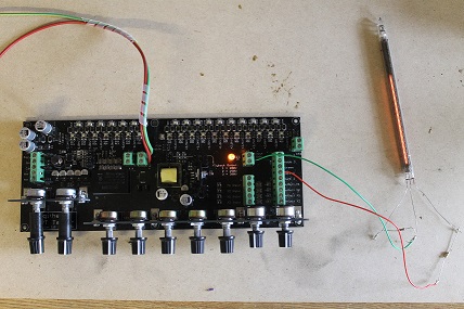 Figure 5 — A neon bargraph indicator lit on the tester — a column of cells or a plasma bar whose lit length tracks the drive. The Mark 2 supplies the strike HV and ballast; the display shows the analogue "sig…