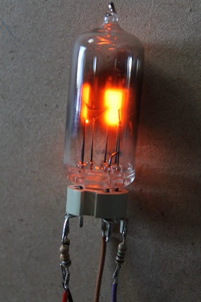 Figure 6 — A GTE175M neon indicator device under test. Like the other cold-cathode types it strikes above its ignition voltage and holds on the maintaining voltage through the tester's ballast. Photo: sgithea…
