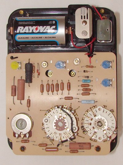 Figure 8 — Inside a Series 8: the printed circuit board, wafer-type range switch, the calibration trimpots that improved on Series 4's PCB, and the movement itself — the physical substrate behind every circui…
